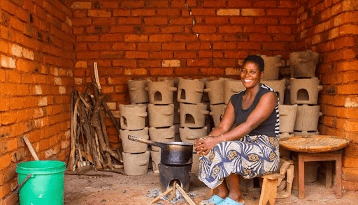 Woman using a clean cookstove in a Malawi workshop, a cookstove carbon project