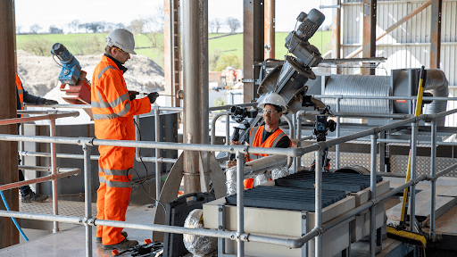 Two operators in hi-vis at a UK biochar plant, a carbon removals project